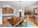 Open kitchen with an island, breakfast table, stainless steel appliances and wood cabinets, perfect for Gathering meals at 13250 Wild Basin Way, Broomfield, CO 80020