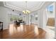 Bright and open living room with hardwood floors, large windows, and a chandelier, excellent for entertaining at 13250 Wild Basin Way, Broomfield, CO 80020