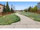 Scenic view of a landscaped neighborhood with a walking path and mature trees at 13250 Wild Basin Way, Broomfield, CO 80020