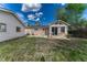 Large backyard with grassy space and patio adjacent to the house and garage at 11957 Claude Ct, Northglenn, CO 80233