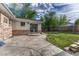 Spacious backyard featuring a concrete patio and mature trees, creating a private and serene outdoor retreat at 11957 Claude Ct, Northglenn, CO 80233