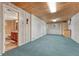 Finished basement with wood paneled walls and ceiling with direct access to the downstairs bathroom at 11957 Claude Ct, Northglenn, CO 80233