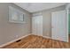 The bedroom features wood-look flooring, ample closet space, and natural light from a window at 11957 Claude Ct, Northglenn, CO 80233