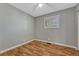 This cozy bedroom features durable wood-look floors, neutral wall paint, and a ceiling fan at 11957 Claude Ct, Northglenn, CO 80233