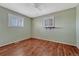 A bright bedroom offers durable wood-look floors, neutral wall paint, and bright light at 11957 Claude Ct, Northglenn, CO 80233