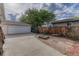 Spacious driveway leading to a detached garage with a fenced backyard at 11957 Claude Ct, Northglenn, CO 80233