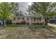Charming single-story brick home with lush front yard and mature trees in a quiet neighborhood setting at 11957 Claude Ct, Northglenn, CO 80233