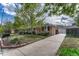 Charming single-story brick home with well-manicured front yard and long driveway at 11957 Claude Ct, Northglenn, CO 80233