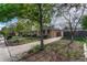 Single-story brick house with mature trees, driveway, and well-kept lawn at 11957 Claude Ct, Northglenn, CO 80233