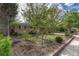 Well-maintained brick home featuring a beautiful front yard with mature trees and landscaping at 11957 Claude Ct, Northglenn, CO 80233