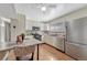 Modern kitchen equipped with stainless steel appliances, white cabinetry, and hardwood floors at 11957 Claude Ct, Northglenn, CO 80233