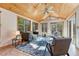 Cozy sunroom with wood ceiling, tile floors, and great natural light at 11957 Claude Ct, Northglenn, CO 80233