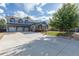 Spacious home featuring an extra wide driveway, three-car garage, well-kept lawn, and charming front porch at 10640 W 46Th Ave, Wheat Ridge, CO 80033