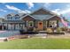 Inviting front porch with rocking chairs, manicured landscaping, and a cheerful front door at 10640 W 46Th Ave, Wheat Ridge, CO 80033