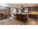 Open-concept kitchen with large island, pendant lighting, stainless steel appliances, and a dining area at 10640 W 46Th Ave, Wheat Ridge, CO 80033