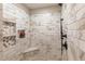 Elegant shower features marble tile, a built-in seat, and a rainfall showerhead at 10640 W 46Th Ave, Wheat Ridge, CO 80033