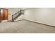 Large finished basement with carpet and a staircase leading to the upper level at 9917 Grove Way # A, Westminster, CO 80031