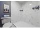 Modern bathroom features white marble-style tiling, a sleek shower, and updated fixtures at 9917 Grove Way # A, Westminster, CO 80031