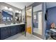 This bathroom features a double sink, black fixtures and an open walk-in closet at 9917 Grove Way # A, Westminster, CO 80031