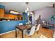 Dining room with wood floors, modern lighting, and an open view to the kitchen at 9917 Grove Way # A, Westminster, CO 80031
