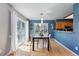 Inviting dining room with hardwood floors, modern lighting, and a view into the kitchen at 9917 Grove Way # A, Westminster, CO 80031