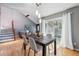 Bright dining room with hardwood floors, modern light fixture, and sliding glass door to the backyard at 9917 Grove Way # A, Westminster, CO 80031