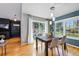 Bright dining room features hardwood floors, a modern light fixture, and sliding glass doors to the backyard at 9917 Grove Way # A, Westminster, CO 80031