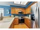 Bright and open kitchen features wood cabinets and stainless steel appliances at 9917 Grove Way # A, Westminster, CO 80031