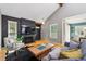 Inviting living room features a dark brick fireplace, wood floors, and large windows for plenty of natural light at 9917 Grove Way # A, Westminster, CO 80031