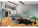 Spacious living room with vaulted ceilings, wood beams, hardwood floors, and a view of the staircase at 9917 Grove Way # A, Westminster, CO 80031