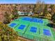 Overhead view of community pickleball courts surrounded by lush trees, with a pool and neighborhood in the background at 9917 Grove Way # A, Westminster, CO 80031