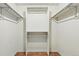Walk-in closet with built-in shelving and wooden floors providing ample storage space at 9917 Grove Way # A, Westminster, CO 80031