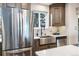 Kitchen with stainless steel appliances, farmhouse sink, and custom cabinetry at 5510 W 103Rd Ave, Westminster, CO 80020