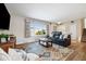 Bright living room featuring hardwood floors, large windows, and comfortable seating at 5510 W 103Rd Ave, Westminster, CO 80020