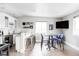Basement bar area featuring updated appliances, countertops, and seating area at 2048 Meade St, Denver, CO 80211
