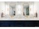 Bathroom features double sinks, designer fixtures, and a marble tile wall at 2048 Meade St, Denver, CO 80211