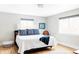 Spacious bedroom with hardwood floors, two windows, and a comfortable bed with bright white covers at 2048 Meade St, Denver, CO 80211