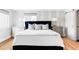 Bright bedroom featuring hardwood floors, wallpaper, and a large window for natural light at 2048 Meade St, Denver, CO 80211