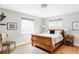 Comfortable bedroom with hardwood floors, a wooden sleigh bed, and natural light from two large windows at 2048 Meade St, Denver, CO 80211