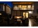 Evening view of the deck, illuminated by a warm fire pit and the home's interior lighting at 2048 Meade St, Denver, CO 80211
