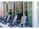 Stylish outdoor seating area with sleek chairs in front of a building with mirrored windows at 2048 Meade St, Denver, CO 80211