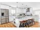 Bright kitchen featuring white cabinets, granite countertops, a stainless steel refrigerator, and hardwood floors at 2048 Meade St, Denver, CO 80211