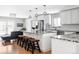 Open-concept kitchen with white cabinets, granite countertops, stainless steel appliances, and a cozy seating area at 2048 Meade St, Denver, CO 80211
