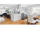 Bright kitchen and dining area with white cabinets, granite countertops, hardwood floors, and modern decor at 2048 Meade St, Denver, CO 80211