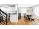 Open kitchen and dining area with stainless steel appliances, granite countertops, and seating for six at 2048 Meade St, Denver, CO 80211