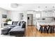 Modern living space adjacent to a bright kitchen, featuring hardwood floors and contemporary decor at 2048 Meade St, Denver, CO 80211