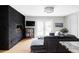 Contemporary living room featuring a black brick fireplace, hardwood floors, and stylish gray sectional sofa at 2048 Meade St, Denver, CO 80211