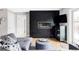 Living room with a modern black accent wall and fireplace, complemented by a comfortable gray sofa at 2048 Meade St, Denver, CO 80211
