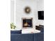 Cozy living room featuring a modern fireplace with stone surround, flat screen TV and stylish decor at 2048 Meade St, Denver, CO 80211