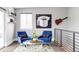 Sitting area featuring blue chairs and a coffee table, with a view from the landing at 2048 Meade St, Denver, CO 80211